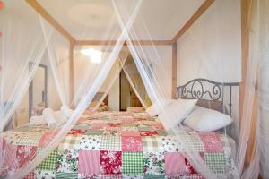 a bedroom with a bed with a canopy at Casa Ohanna in Vejer de la Frontera +29 photos