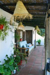 an outdoor patio with a couch and a pergola at Casa Ohanna in Vejer de la Frontera