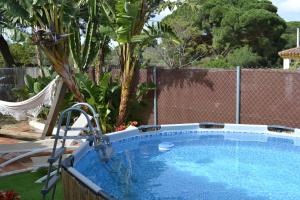 a swimming pool in a yard next to a fence at Casa Ohanna in Vejer de la Frontera