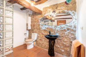 a stone bathroom with a sink and a toilet at La Casuna in Olba +37 photos