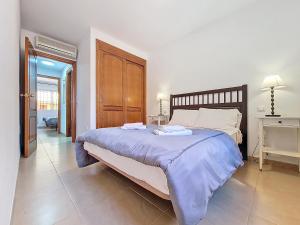 a bedroom with a large bed with two towels on it at Albatros Playa 3 - 1207 in Mar de Cristal +34 photos