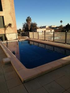 a swimming pool in front of a building at Deltebre riu in Deltebre