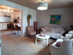 a living room with a couch and a table at Kinderfreundlich Am Dorflädchen in Blankenheim