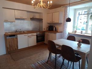 a kitchen with a table and a dining room at Kinderfreundlich Am Dorflädchen in Blankenheim