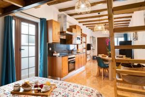 a kitchen with wooden cabinets and a table with a dining room at El rinconcito de Jess in El Golfo