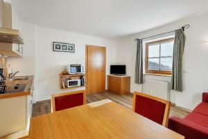 a living room with a table and a kitchen at New - Steinhof Val di Mezzo in Val di Mezzo
