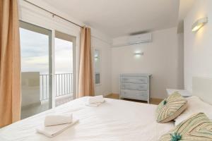 a bedroom with a bed with a large window at La Perla vista al mar Fabiola 1 in Calpe +23 photos