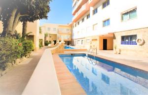 a swimming pool in front of a building at La Perla vista al mar Fabiola 1 in Calpe