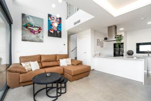 a living room with a couch and a table at R-40-B Luxury Villa with pool in Los Montesinos