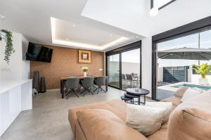 a living room with a couch and a table at R-40-B Luxury Villa with pool in Los Montesinos