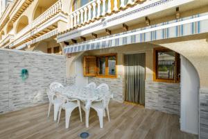 a white table and chairs on a patio at Los Arenales al Sol in Arenales del Sol