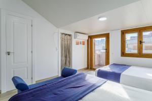 a bedroom with two beds and a window at Los Arenales al Sol in Arenales del Sol +20 photos
