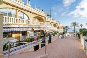a building with a walkway in front of it at Los Arenales al Sol in Arenales del Sol