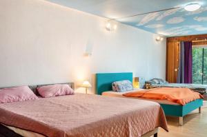a bedroom with two beds and a blue ceiling at Ferienwohnung Brenda in Schillingsfürst