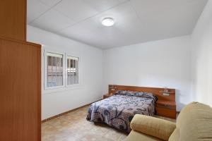 a bedroom with a bed and a window at Casa Menvil in Sant Jordi de Cercs