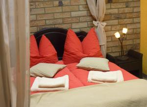 a bed with red and white pillows on it at Ferienwohnung Hasi 2 am Kurpark in Bad Frankenhausen +36 photos