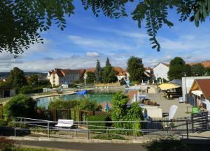 a view of a swimming pool in a town with houses at Ferienwohnung Hasi 2 am Kurpark in Bad Frankenhausen