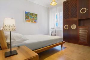 a bedroom with a bed and a table with a lamp at La Casa Del Marinaio in Rapallo