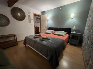 a bedroom with two beds and a tv in it at Chambre d'hôte Léontine in Lamagistère