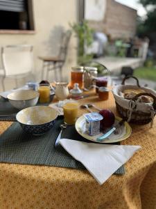 a table with plates of food on a table at Chambre d'hôte Léontine in Lamagistère