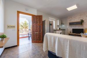 a kitchen with a table and a refrigerator at Nazareno in Níjar