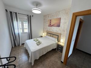 a bedroom with a bed and a table and a window at Nazareno in Níjar