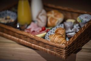 a basket filled with different types of bread and pastries at Rueper Hof Chalet Ruipa in Valdaora