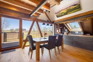a kitchen and dining room with a table and chairs at I'd Love To Be Home in Bidingen