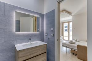a bathroom with a sink and a mirror at Appartamenti a 50 m dal mare in Torre San Giovanni Ugento +62 photos