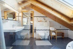 a bathroom with a sink and a toilet in a room at I'd Love To Be Home in Bidingen +22 photos