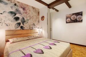 a bedroom with a bed with purple shoes on it at Maison de Doi - Chatillon in Châtillon