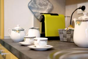 a counter with cups and tea cups on it at Maison de Doi - Chatillon in Châtillon