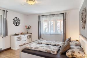 a bedroom with a bed and a dresser at Andis Ferienwohnung in Farchant