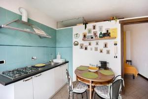 a kitchen with a table and a sink and a stove at Casa Pepe in Imperia +20 photos