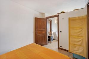a bedroom with a bed and a wooden door at Casa Pepe in Imperia