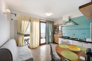 a living room with a table and a kitchen at Casa Pepe in Imperia
