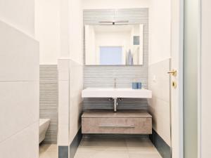 a bathroom with a sink and a mirror at Porta a Mare Home in Portoferraio +34 photos