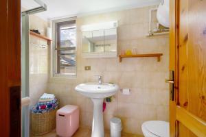a small bathroom with a sink and a toilet at Casa Savin 35 in Pontboset