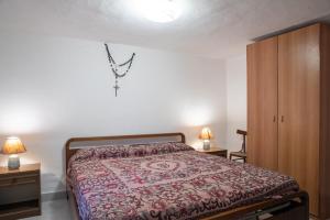 a bedroom with a bed and two night stands at Runcina 2 in San Teodoro