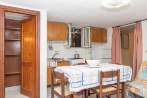 a kitchen with a table with chairs and a table and a table at Runcina 2 in San Teodoro