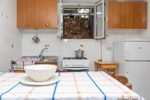 a kitchen with a table with a white bowl on it at Runcina 2 in San Teodoro +17 photos