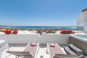 a view of the beach from the balcony of a resort at Superb Large Apartment on the Beach in Marbella