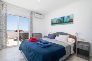 a bedroom with a bed with two towels on it at Superb Large Apartment on the Beach in Marbella