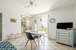 a room with a table and a tv and a bedroom at Cap Sur L’océan - 481 in Pornic