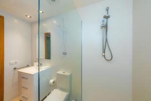a bathroom with a shower and a toilet and a sink at Piso Claudia in Port de Pollensa +19 photos