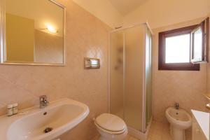 a bathroom with a sink and a toilet and a shower at Casa Vacanze Fragola in Olbia +9 photos