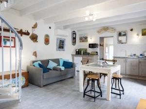 a kitchen and living room with a table and a couch at Gite Atelier La Croix Blanche in Kermaria-Sulard +29 photos