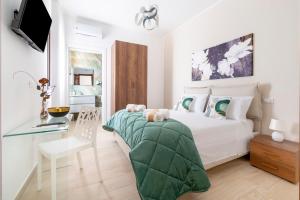 a bedroom with a bed and a desk and a television at Quintessenza – Boutique Rooms in Leverano +86 photos