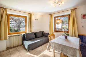 a living room with a couch and a table at Gartnerhof Apt Rose in Colle Isarco