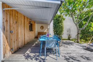 a blue table and chairs on a patio at Maison Côté Bassin in Arcachon
